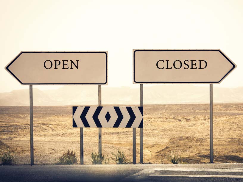 open and closed signs on highway